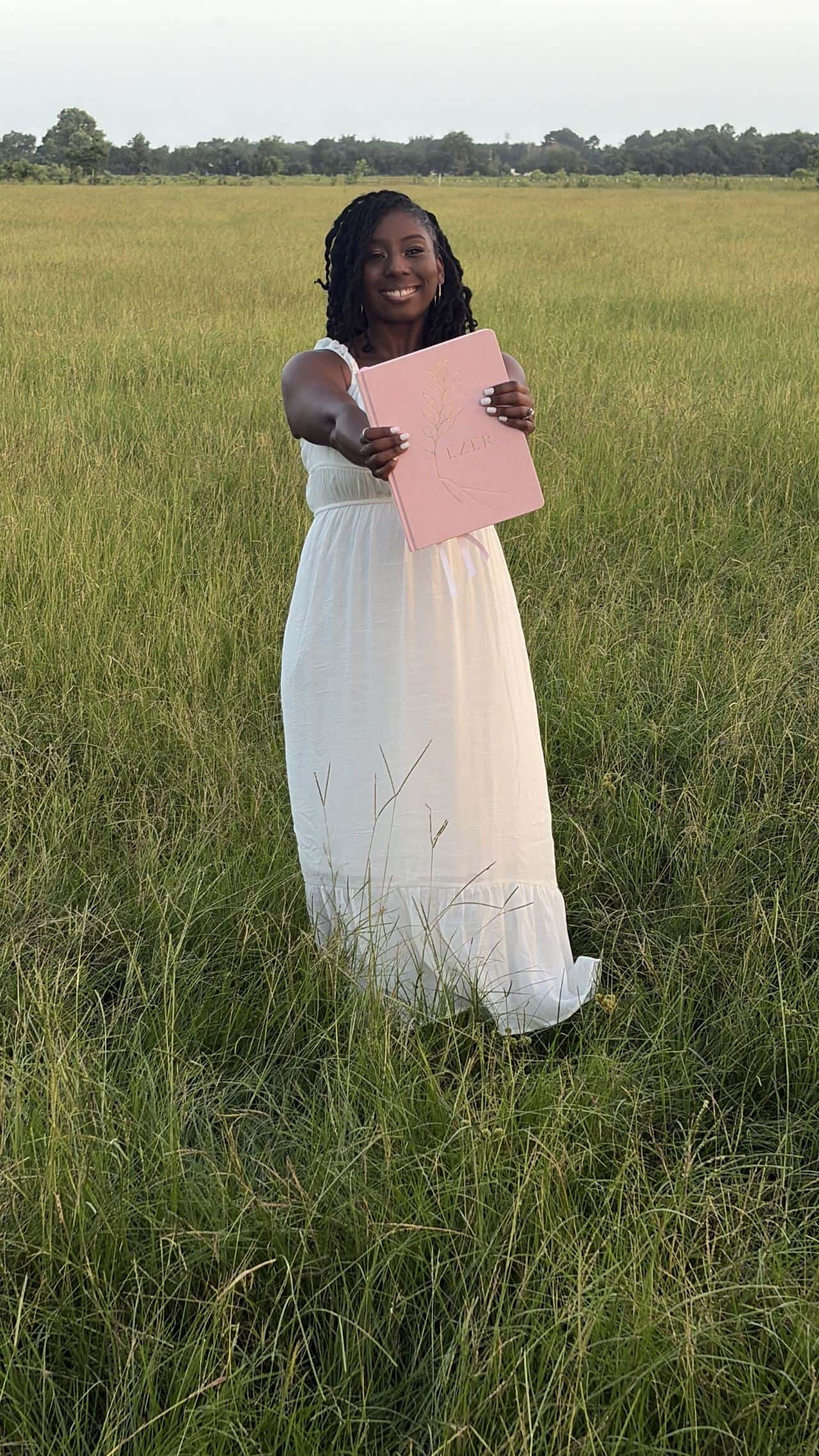 Moriah Offord, founder of Ezer Circle, smiling in a field