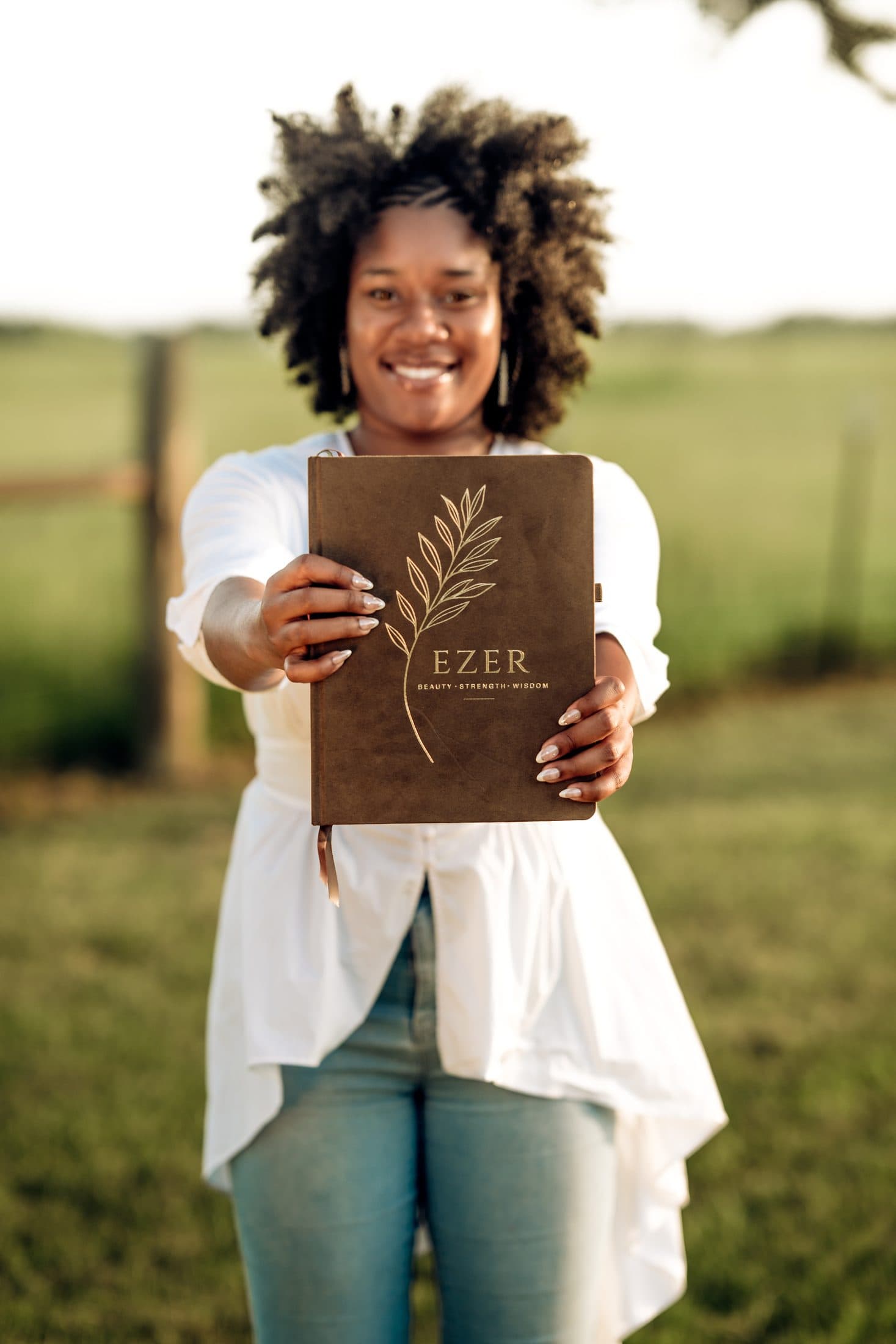 Moriah Offord holding the Ezer Planner outdoors
